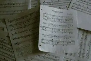 A pile of sheet music sitting on top of a table