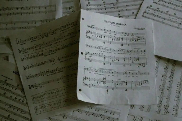 A pile of sheet music sitting on top of a table